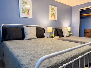 Rest comfortably in this spacious bedroom featuring two cozy queen beds, stylish decor, and plenty of natural light. Perfect for families or friends traveling together.