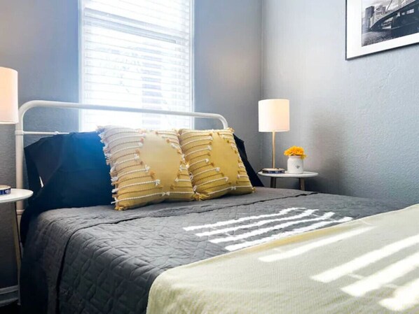 The bedroom’s serene ambiance invites you to relax, with a plush bed that promises a restful night's sleep.