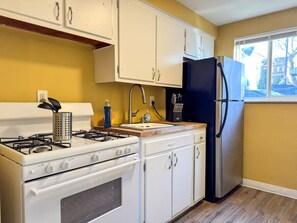 Cook with ease in this well-equipped kitchen featuring stainless steel appliances, ample cabinetry, and a stylish backsplash. Whether you're brewing coffee or preparing a gourmet meal, this space is designed for functionality and style, making every meal