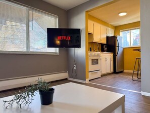 You feel at home as you settle into the living room, where the inviting atmosphere is perfect for lounging or entertaining.
