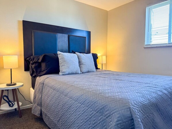 Rest comfortably in this spacious bedroom featuring two cozy queen beds, stylish decor, and plenty of natural light. Perfect for families or friends traveling together.