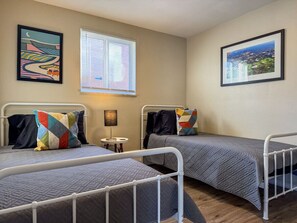 Luxurious twin bedroom featuring a comfortable bed, elegant decor, and plenty of natural light for a rejuvenating sleep.