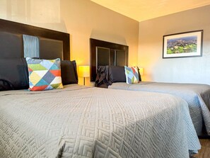 Rest comfortably in this spacious bedroom featuring two cozy queen beds, stylish decor, and plenty of natural light. Perfect for families or friends traveling together.