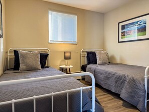 As you settle into the twin beds, you’re surrounded by a calming ambiance that promises a peaceful night’s sleep.