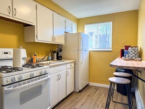As you open the kitchen, you discover an assortment of coffee pods, and sugar, ensuring you have everything you need for a perfect morning or afternoon pick-me-up.