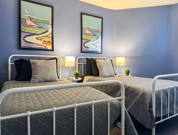 As you settle into the twin beds, you’re surrounded by a calming ambiance that promises a peaceful night’s sleep.