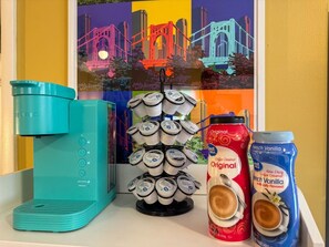 The coffee station is thoughtfully equipped with a variety of in-house consumables, including a selection of ground coffee, sweeteners, and creamers to suit every taste.