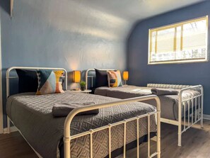 As you settle into the twin beds, you’re surrounded by a calming ambiance that promises a peaceful night’s sleep.