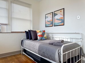 The room’s soft lighting and comfortable twin beds create a serene space perfect for relaxation and restful nights.