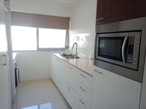 Cook in style with our fully equipped modern kitchen, featuring high-end appliances, ample counter space, and everything you need for delicious meals.