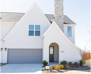 Features a two-car garage and a large, fenced backyard