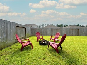 Family and pet friendly fully fenced backyard with a firepit