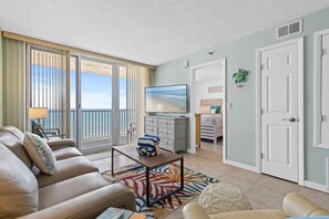 Unwind in a spacious living room featuring ocean views, comfortable seating, and modern coastal decor.