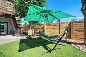 Kick back on the patio with a relaxing hammock and a BBQ grill, perfect for outdoor gatherings.