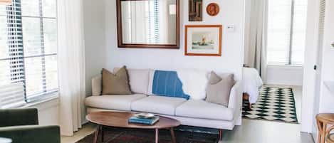 Step into the inviting living room, perfect for winding down after a day of adventure. Sink into the comfy sofa and kick back, whether you're binging your favorite series on the large-screen TV or enjoying a peaceful night in. This space is all about comfort and entertainment—make yourself at home!