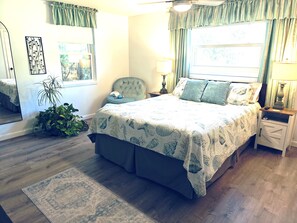 Roomy bedroom with charging ports on bedside lamps.