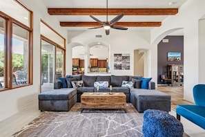 Main Living room featuring plenty of seating, gas fireplace, smart TV, Dining Table and access to the backyard.