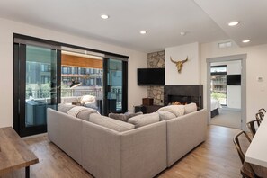 Open living area with gas fire place, smart TV that opens to outdoor patio