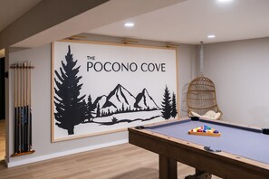 Game room with Mural, Swinging chair, Pool table, Giant Connect 4 + more