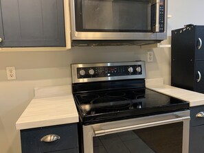 Full kitchen with refrigerator, owen, microwave, and dishwasher.