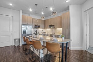 Set the table for memorable meals in this beautifully arranged dining area. With elegant place settings and a charming centerpiece, it's perfect for hosting dinner parties or enjoying family dinners in a cozy and stylish atmosphere.