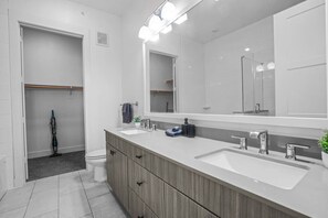As you step into the bathroom, the clean lines and soothing colors create a space where you can relax and refresh.