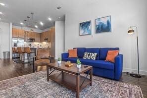 The living room is filled with natural light, creating a bright and welcoming space that invites relaxation.