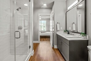 You feel a sense of calm as you enter the bathroom, where the thoughtful design and high-quality materials create a serene environment.