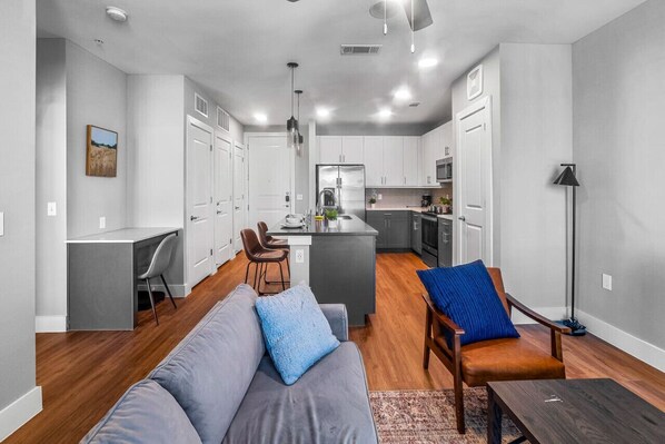 Bright and airy living room with plush seating, a large TV, and tasteful decor, creating the perfect space for relaxation and entertainment.