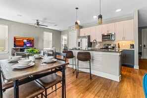 Set the table for memorable meals in this beautifully arranged dining area. With elegant place settings and a charming centerpiece, it's perfect for hosting dinner parties or enjoying family dinners in a cozy and stylish atmosphere.