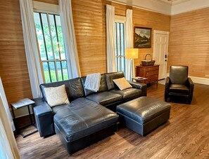 Spacious living room with comfortable seating and a large Roku TV.