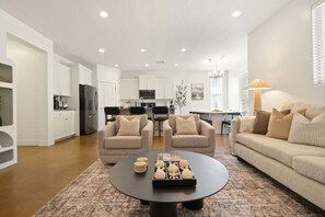 Large living room with oversized sectional and 2 swivel chairs
