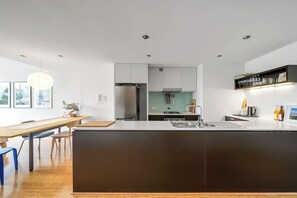 The modern kitchen comes fully equipped for your holiday catering with sleek appliances and cooking utensils.
