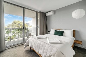 The primary bedroom benefits from a queen-sized bed, balcony access and private ensuite bathroom.
