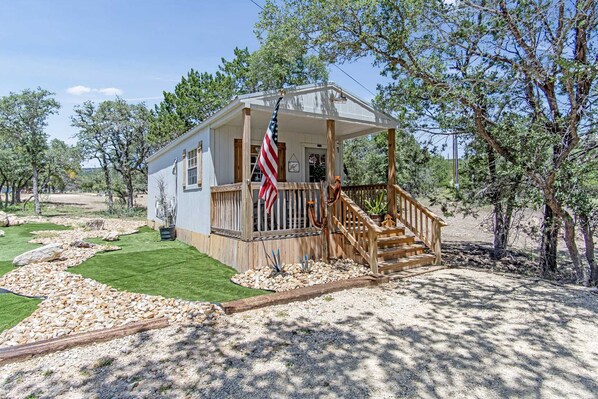 The Shooting Star Cabin is peacefully nestled in the shade on the ranch...and it's got air conditioning and heating inside, too!