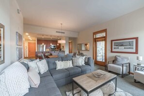 This bright and welcoming living area, with view of the Snowmass Gondola, features a pull-out sofa bed, flat screen TV