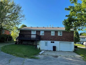 large parking area and garage in a fenced yard