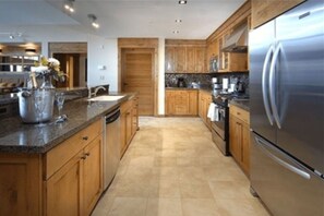 Gourmet kitchen with top-of-the-line appliances and plenty of space for cooking.