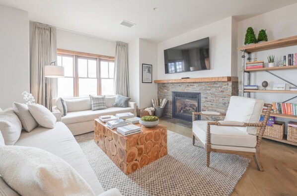 Bright and cozy living room with a fireplace, perfect for relaxing and unwinding.