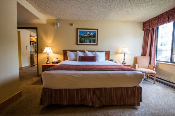 Spacious bedroom with a comfortable bed and ample natural light for a restful stay.