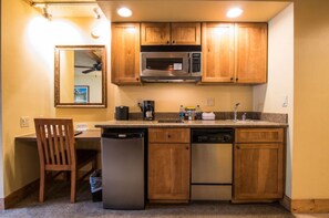 Compact kitchenette equipped with all the essentials for a convenient stay.