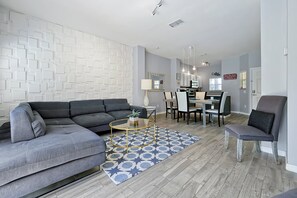 Experience modern comfort in our open-concept living and dining area, featuring stylish decor, cozy seating, and a sleek dining space for memorable meals.