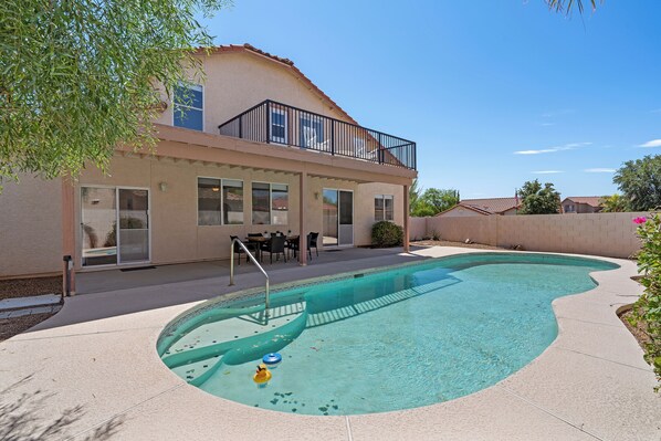 Pool: Sparkingly clean pool surrounded by desert plants 