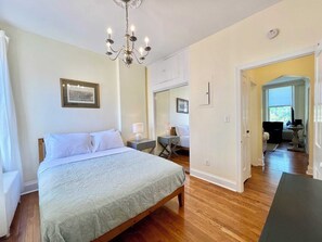 Rest and rejuvenate in a space where heritage meets harmony: this tranquil bedroom, with its carefully chosen art, invites you to unwind after a day exploring the storied streets of Old Town Alexandria.