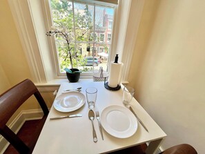Dine in delight with a view: Enjoy intimate meals in this sunlit nook, featuring a charming street view from the heart of Old Town Alexandria, where every bite is accompanied by the city's historic ambiance.