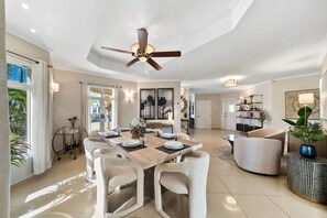- This dining area features a chic table that comfortably seats six - A stylish ceiling fan and elegant decor that invites relaxation and social gatherings - The space seamlessly connects to the living room, creating a cozy, open environment