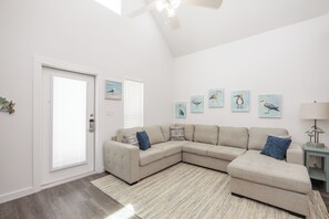 Newly updated living space with cozy sectional that turns into a full size sleeper sofa