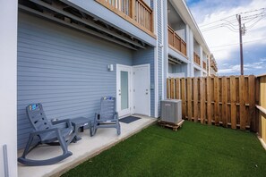 Private, fenced in patio off the master bedroom with chairs, turf and access out the back gate