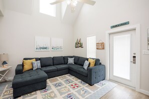 Newly updated living space with cozy sectional that turns into a full size sleeper sofa and coastal decor throughout