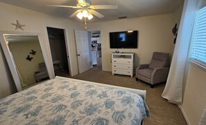 Main bedroom with King size bed, walk in closet, TV, private bathroom.